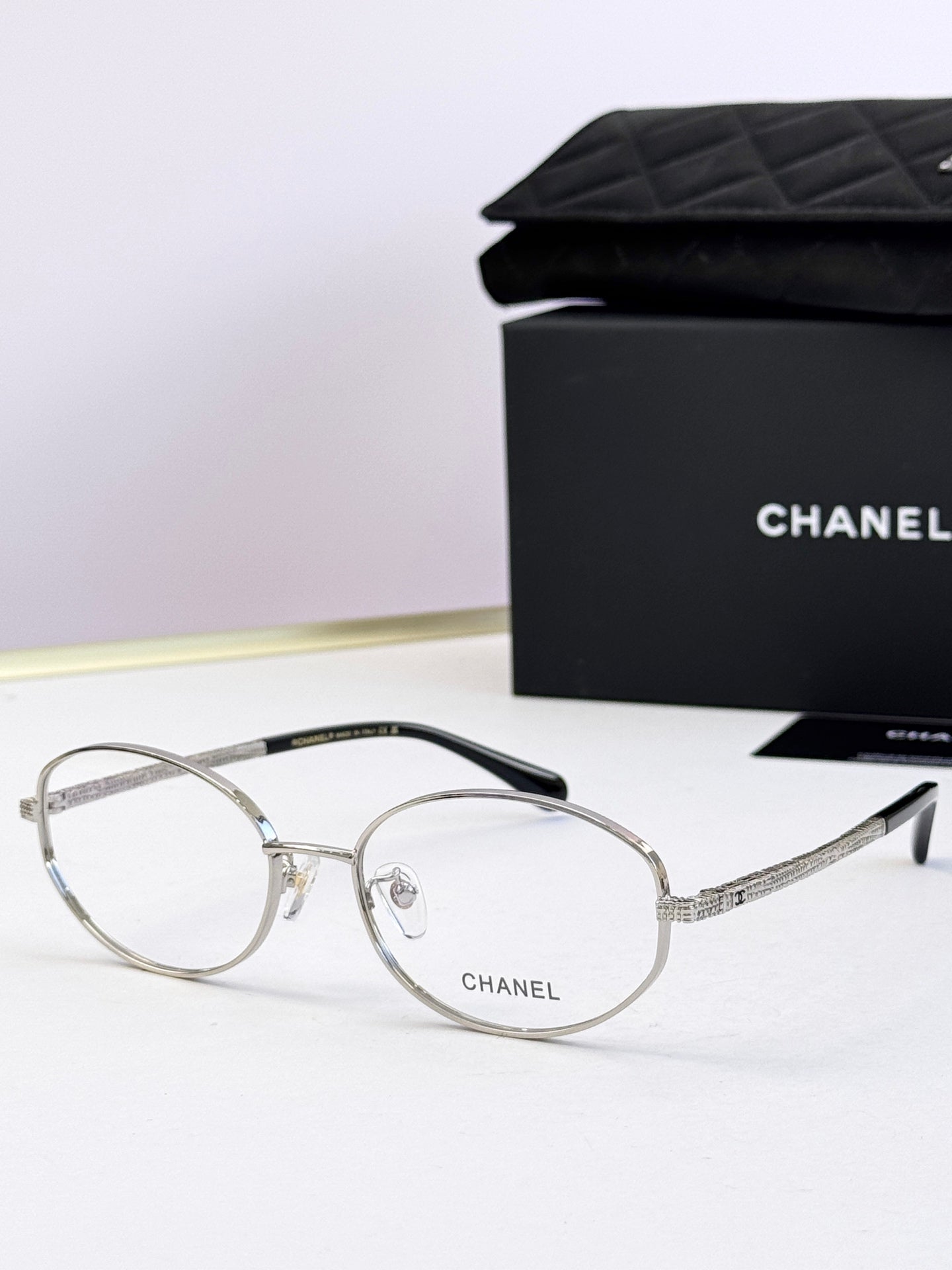 Chanel eyeglasses with silver round frames and clear lenses