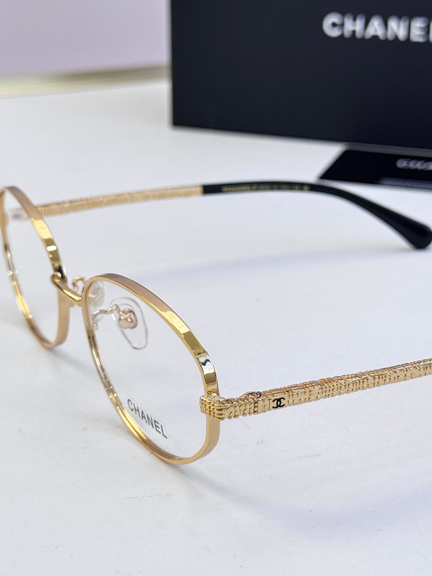 Chanel eyeglasses side view with gold metal frame and dark temples