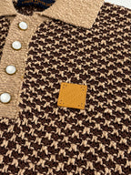 Knit polo shirt close-up with tan button placket and small rectangular logo patch