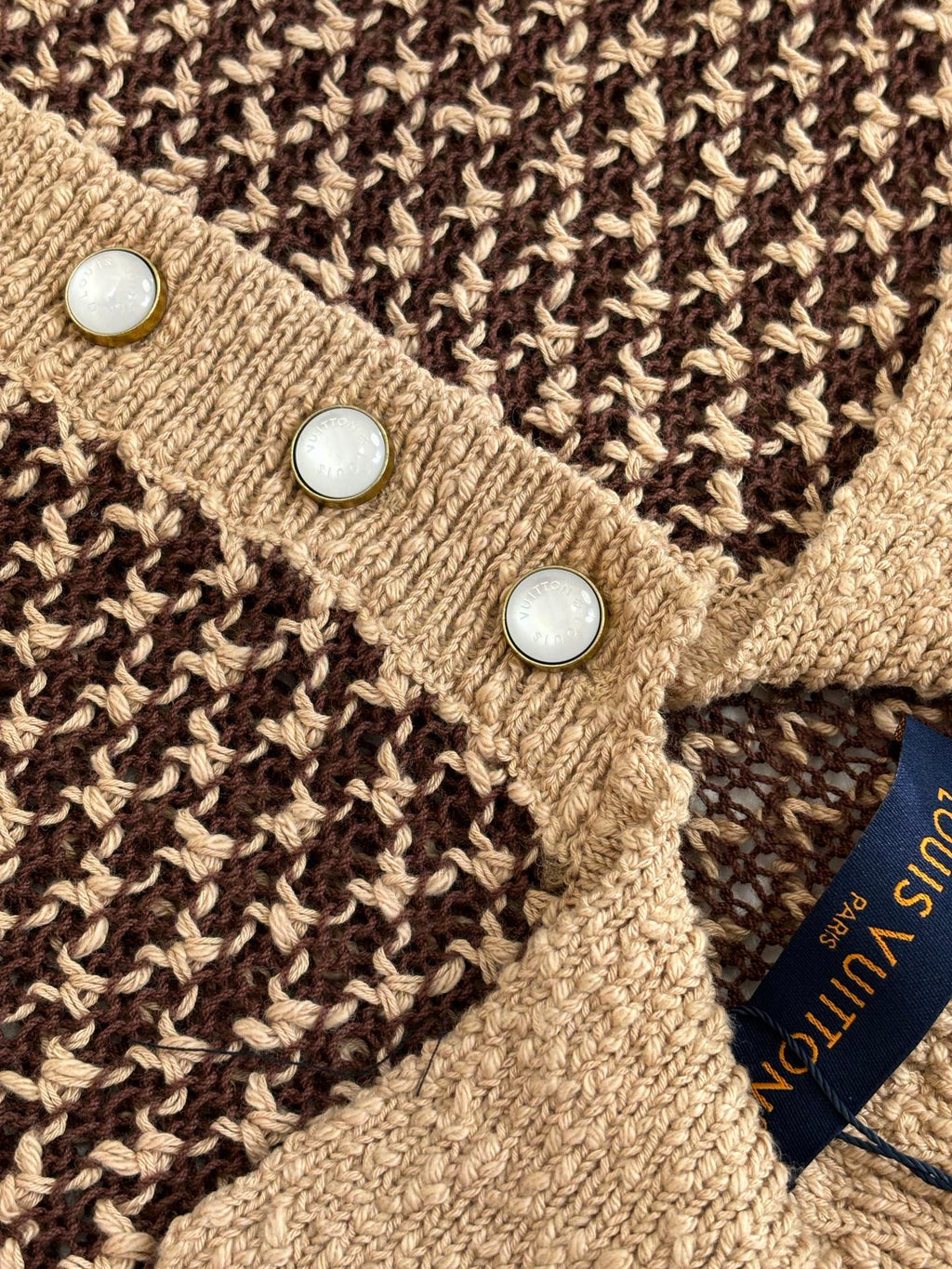 Knit polo shirt close-up of tan placket with three white buttons