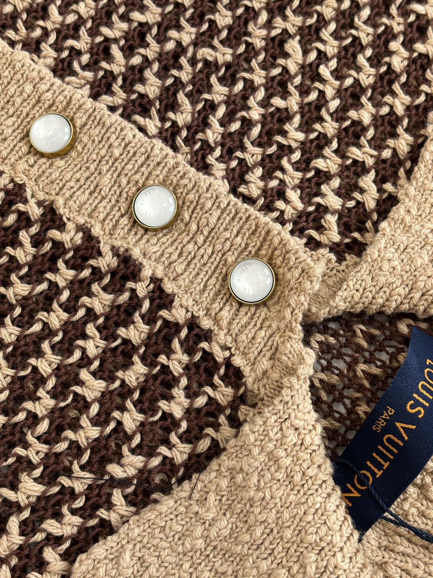 Knit polo shirt close-up of tan placket with three white buttons
