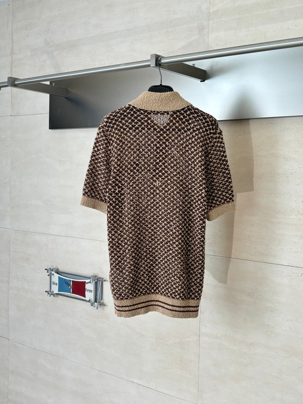 Knitted polo shirt with all-over brown patterned stitch, tan collar and hem stripes