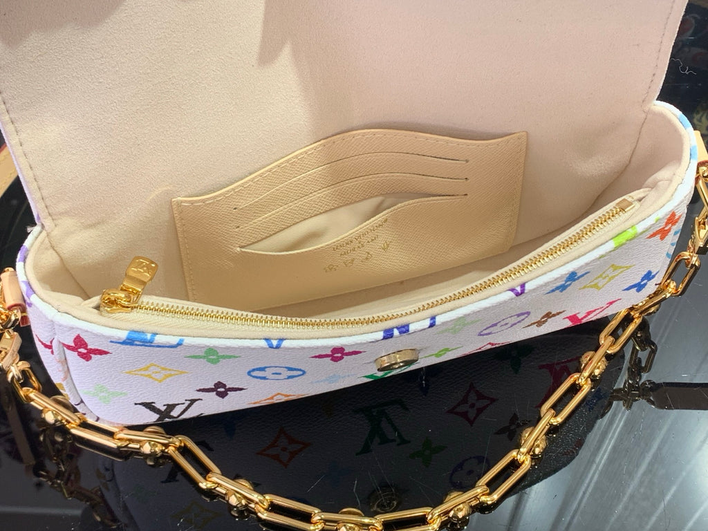 Open Louis Vuitton crossbody bag showing beige fabric lining and zipped interior
