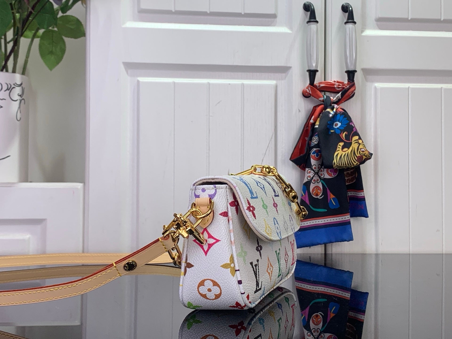 White Louis Vuitton crossbody bag with multicolor monogram, gold chain and adjustable shoulder strap
