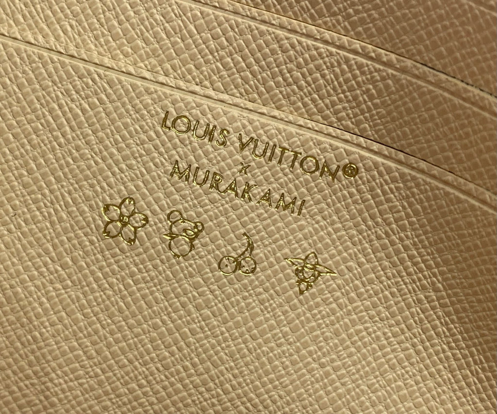 Louis Vuitton embossed logo on beige leather base with small multicolor monogram motifs