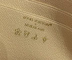 Louis Vuitton embossed logo on beige leather base with small multicolor monogram motifs
