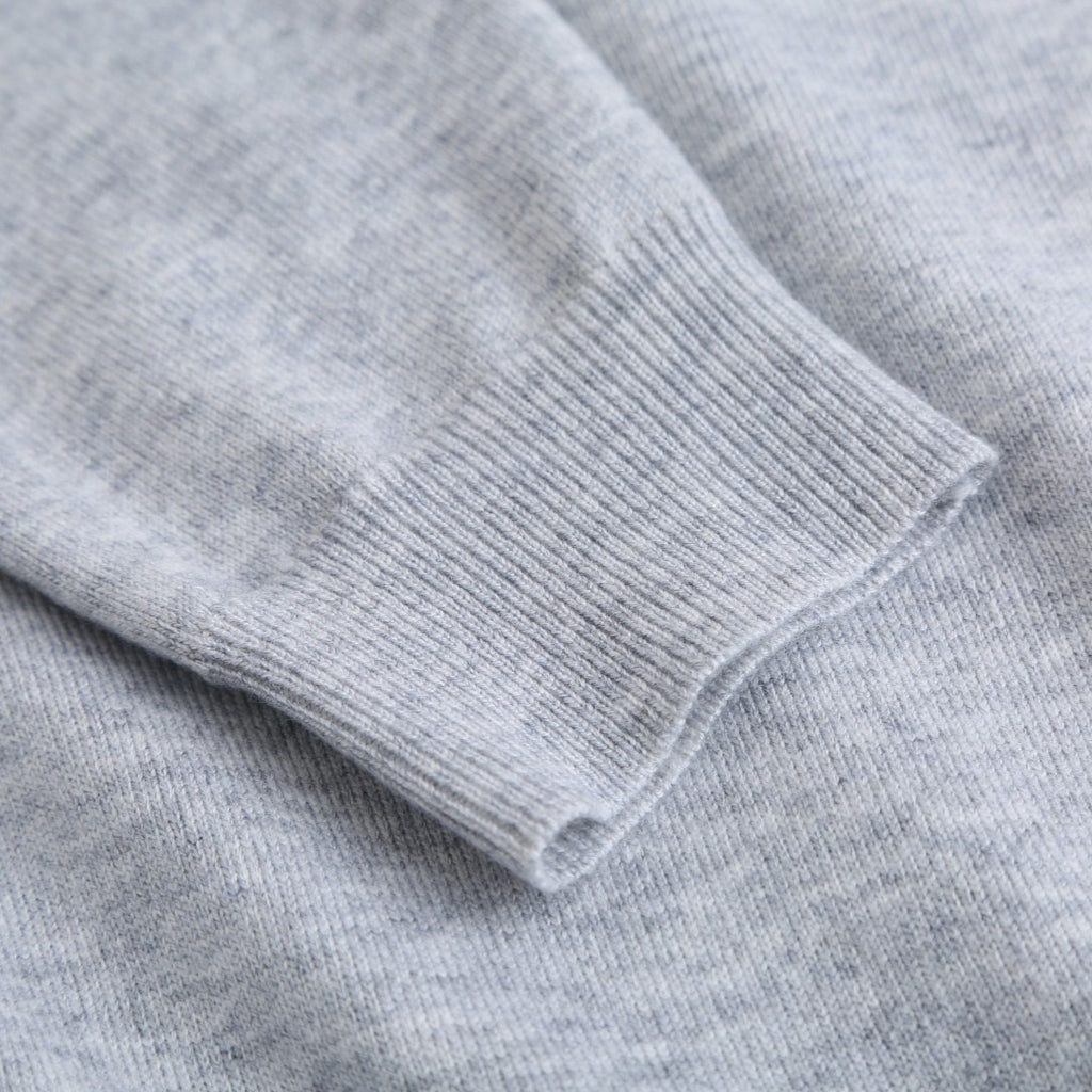 Light gray sweatshirt cuffs and hem with ribbed knit finish.