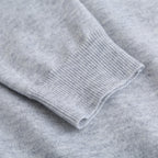 Light gray sweatshirt cuffs and hem with ribbed knit finish.
