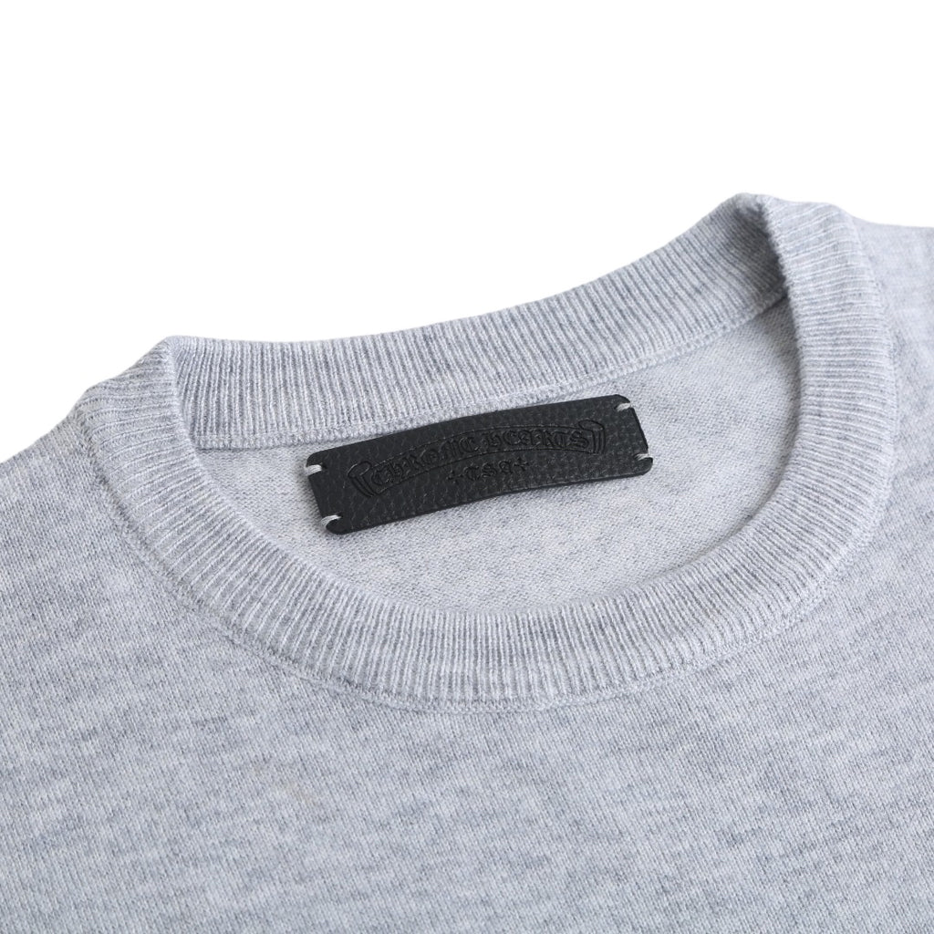 Light gray crewneck sweatshirt with black brand label at the neckline.