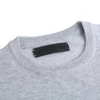 Light gray crewneck sweatshirt with black brand label at the neckline.