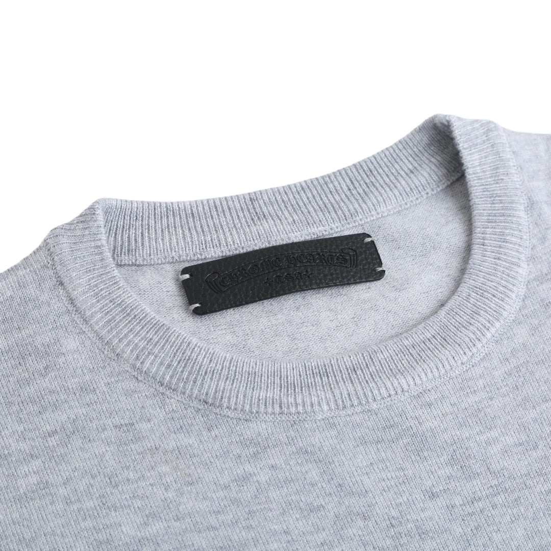 Light gray crewneck sweatshirt with black brand label at the neckline.