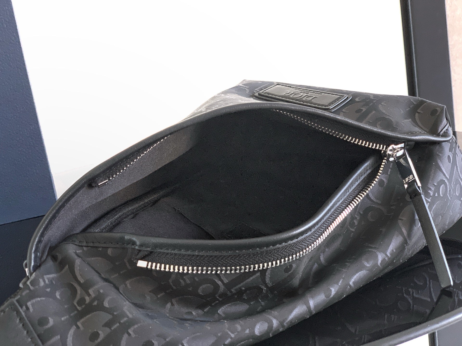 Dior monogram bag interior view with zippered pocket and dark lining