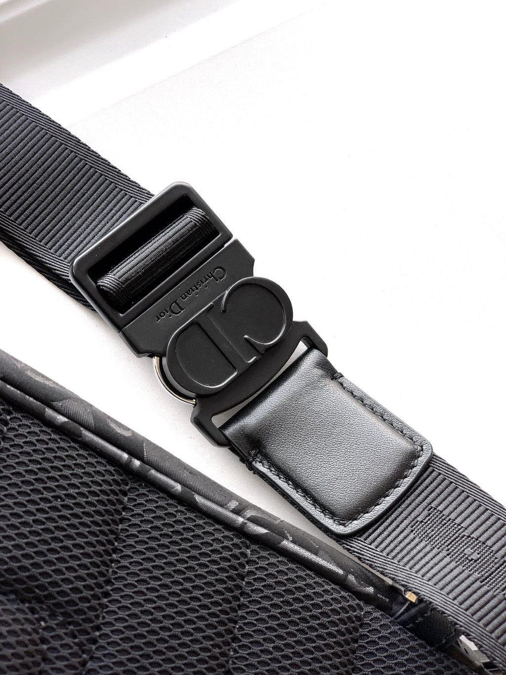 Dior bag strap hardware with adjustable buckle and stitched strap end