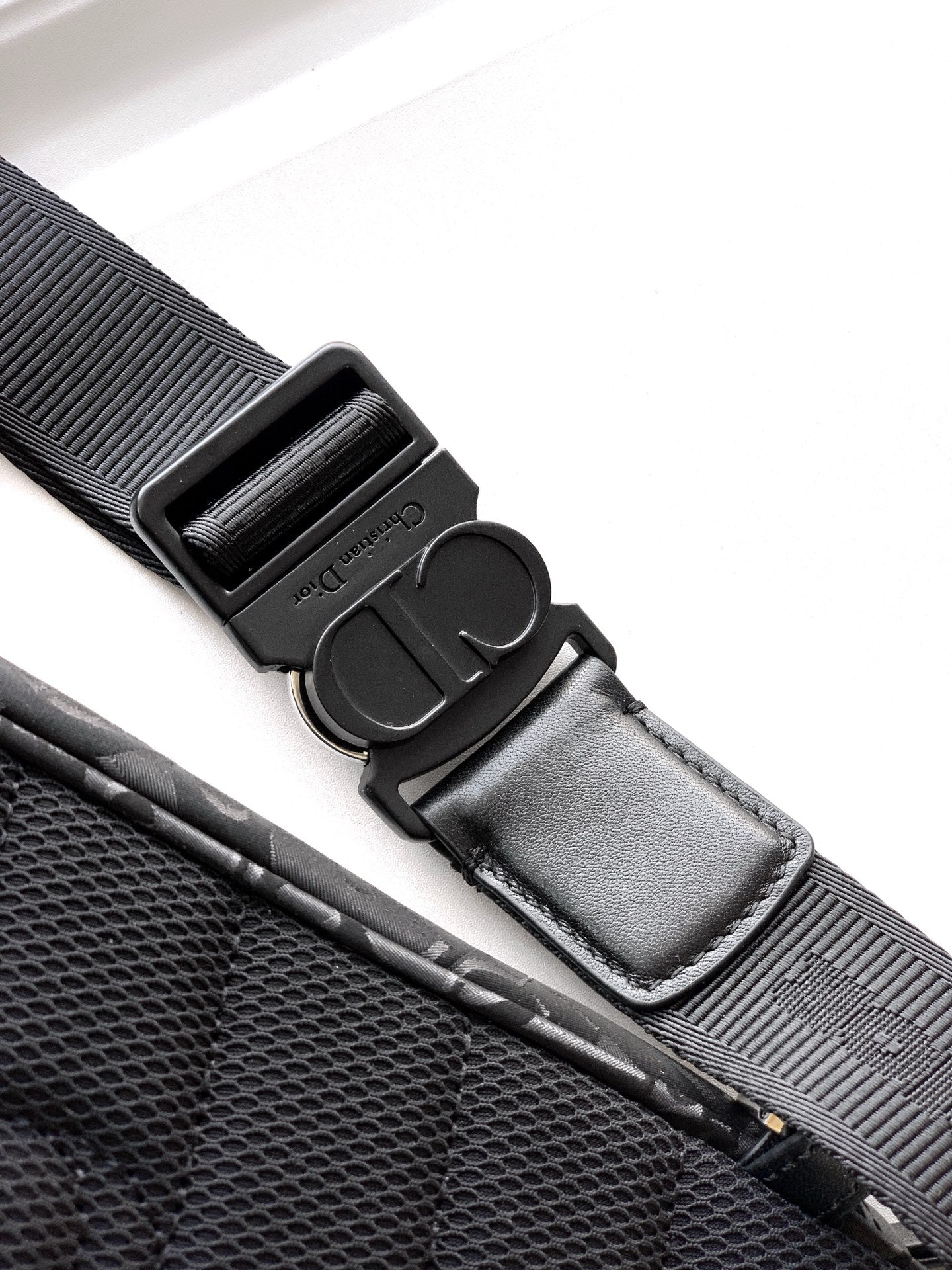 Dior bag strap hardware with adjustable buckle and stitched strap end