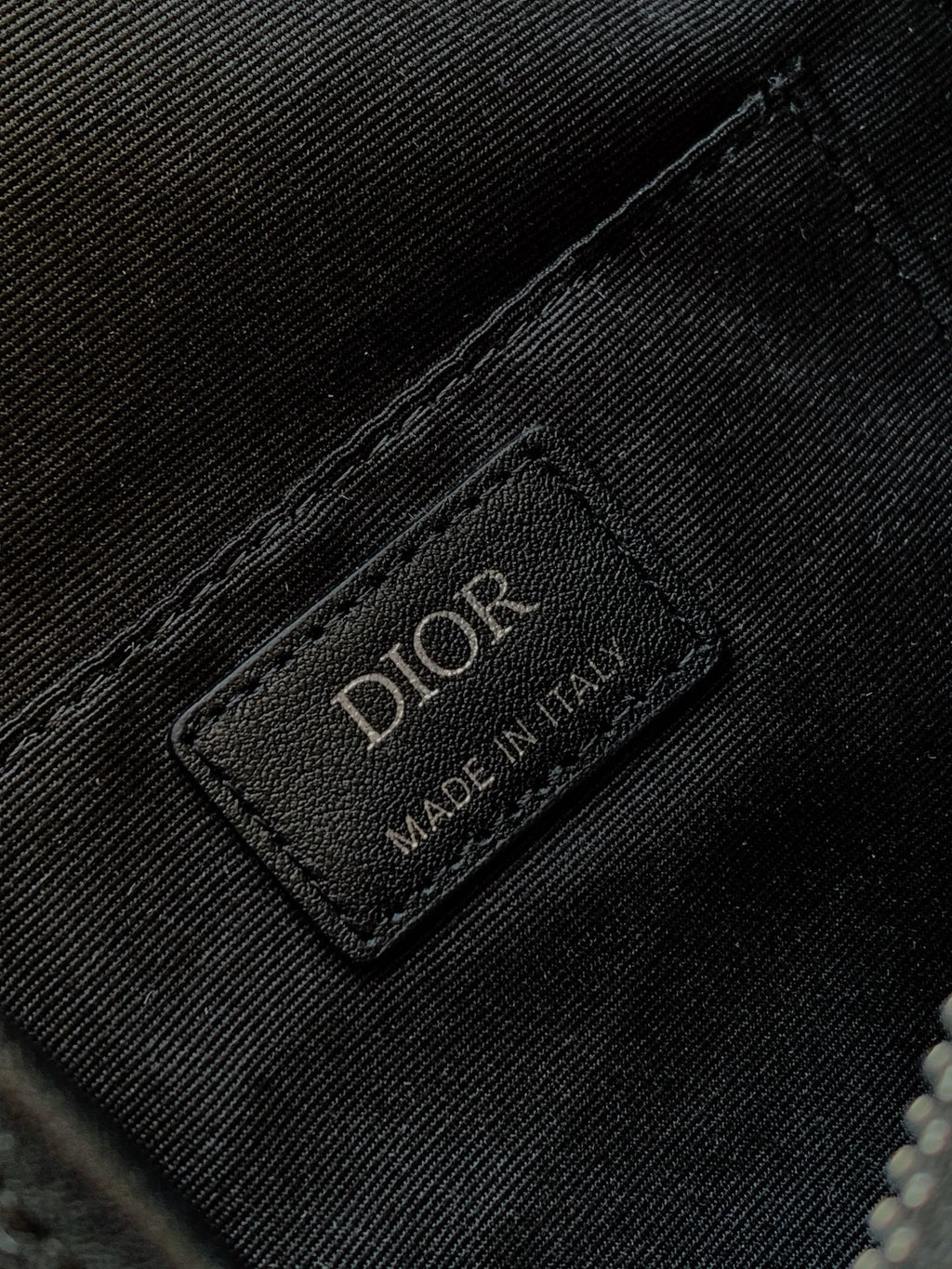 Dior bag brand label patch on textured fabric