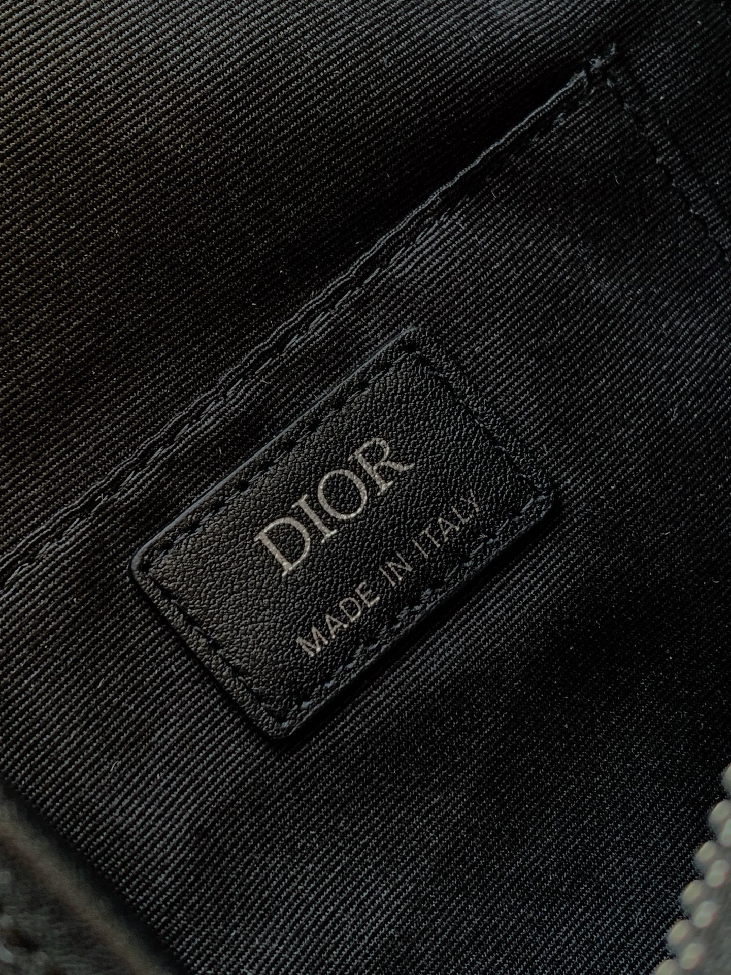 Dior bag brand label patch on textured fabric