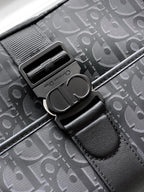 Dior bag hardware close-up with clasp and black leather trim on Oblique canvas