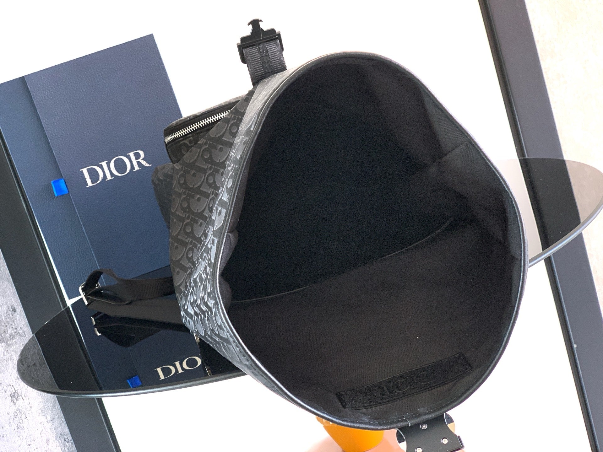 Dior black monogram bucket-style bag with open top and black fabric lining