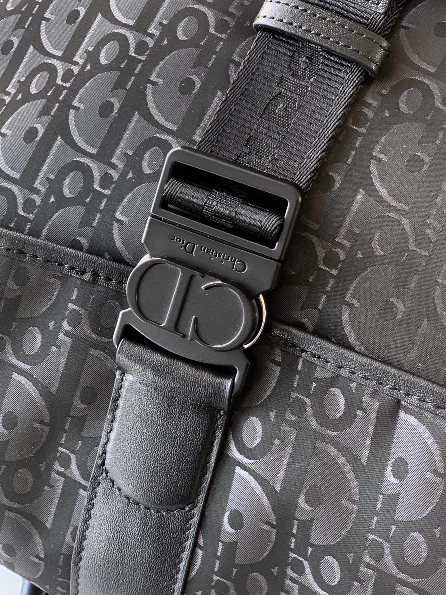 Dior monogram bag hardware: textured strap with black buckle and D-ring