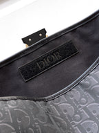 Dior bag interior with black fabric lining and Dior logo patch
