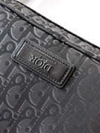 Dior monogram bag logo patch on dark fabric, stitched onto the flap