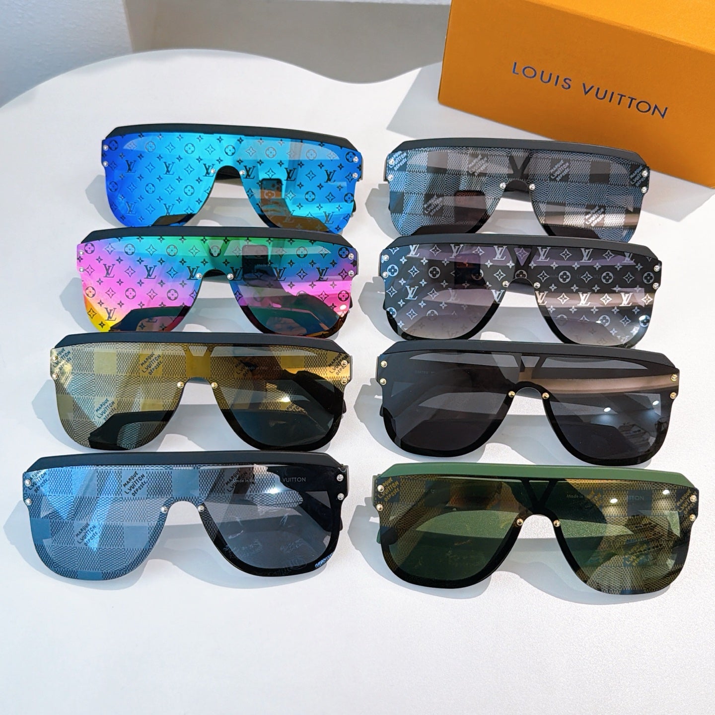 Set of multicolor designer sunglasses on display with black frames