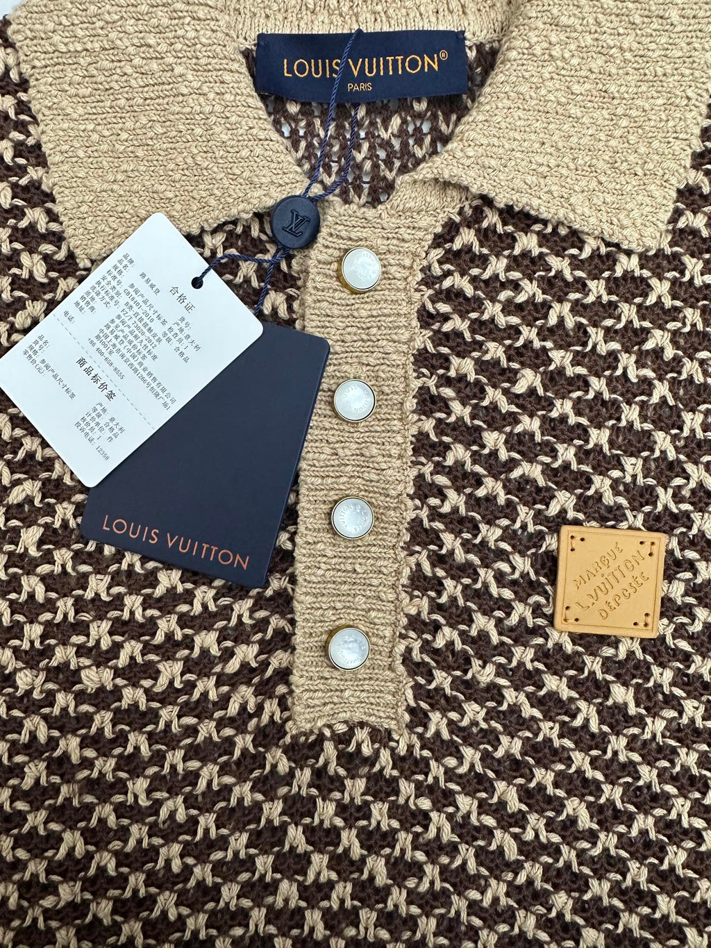 Louis Vuitton knit polo close-up: blue buttons, gold logo patch, textured knit