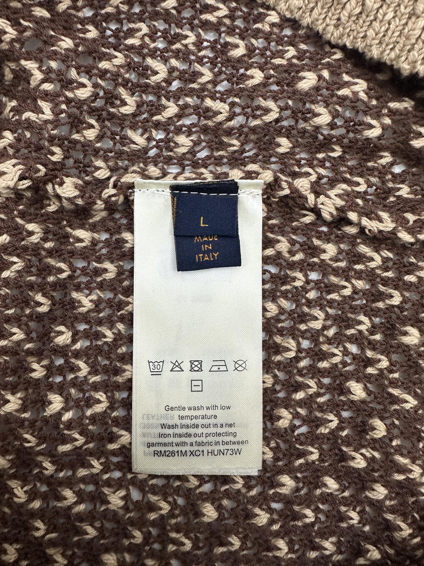 Louis Vuitton garment label on knit polo fabric, 'MADE IN ITALY' tag