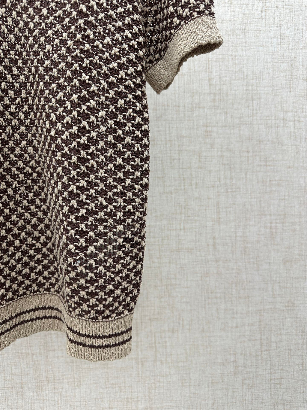 Louis Vuitton knit polo side view, striped hem and cream cuff detail