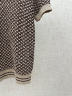Louis Vuitton knit polo side view, striped hem and cream cuff detail