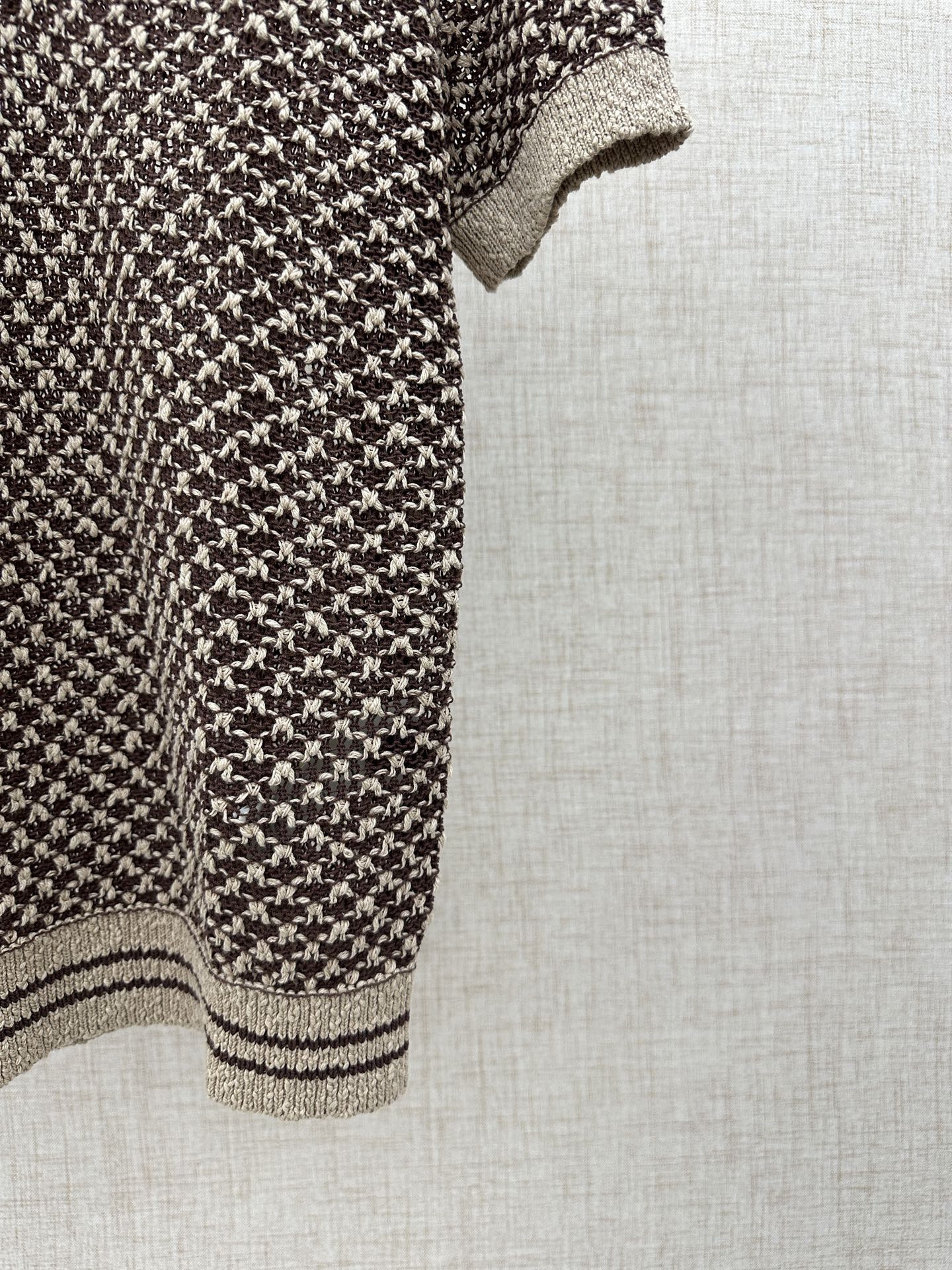Louis Vuitton knit polo side view, striped hem and cream cuff detail