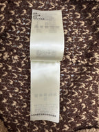 Louis Vuitton care label on knit polo fabric with wash symbols and materials info