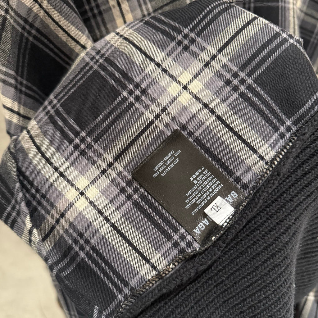 Balenciaga long-sleeve sweater care label on plaid fabric with size info