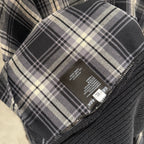 Balenciaga long-sleeve sweater care label on plaid fabric with size info