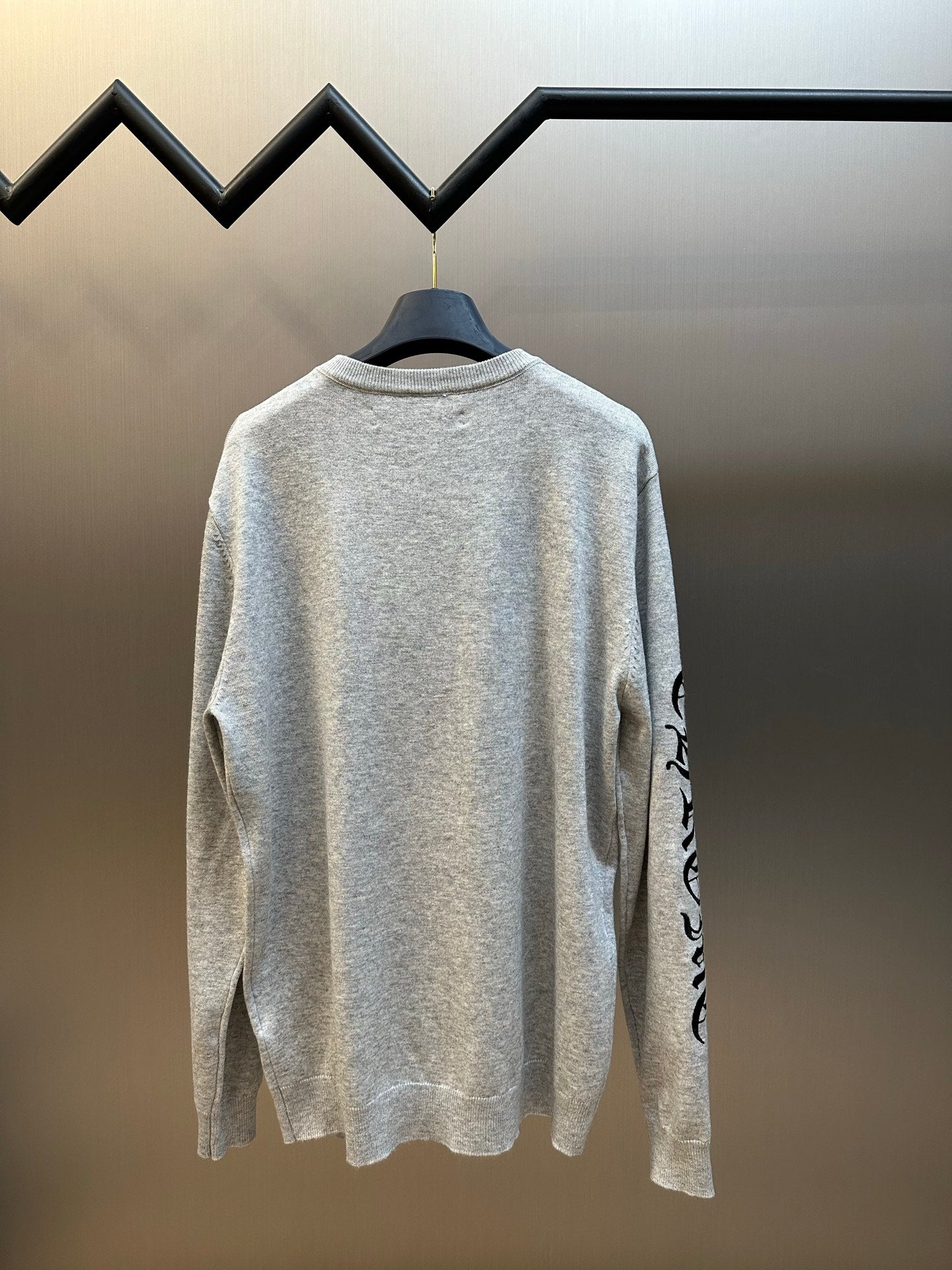 Light gray heather crewneck sweatshirt back view with black side sleeve graphic