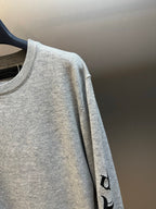 Light gray heather sweatshirt sleeve with black vertical graphic print