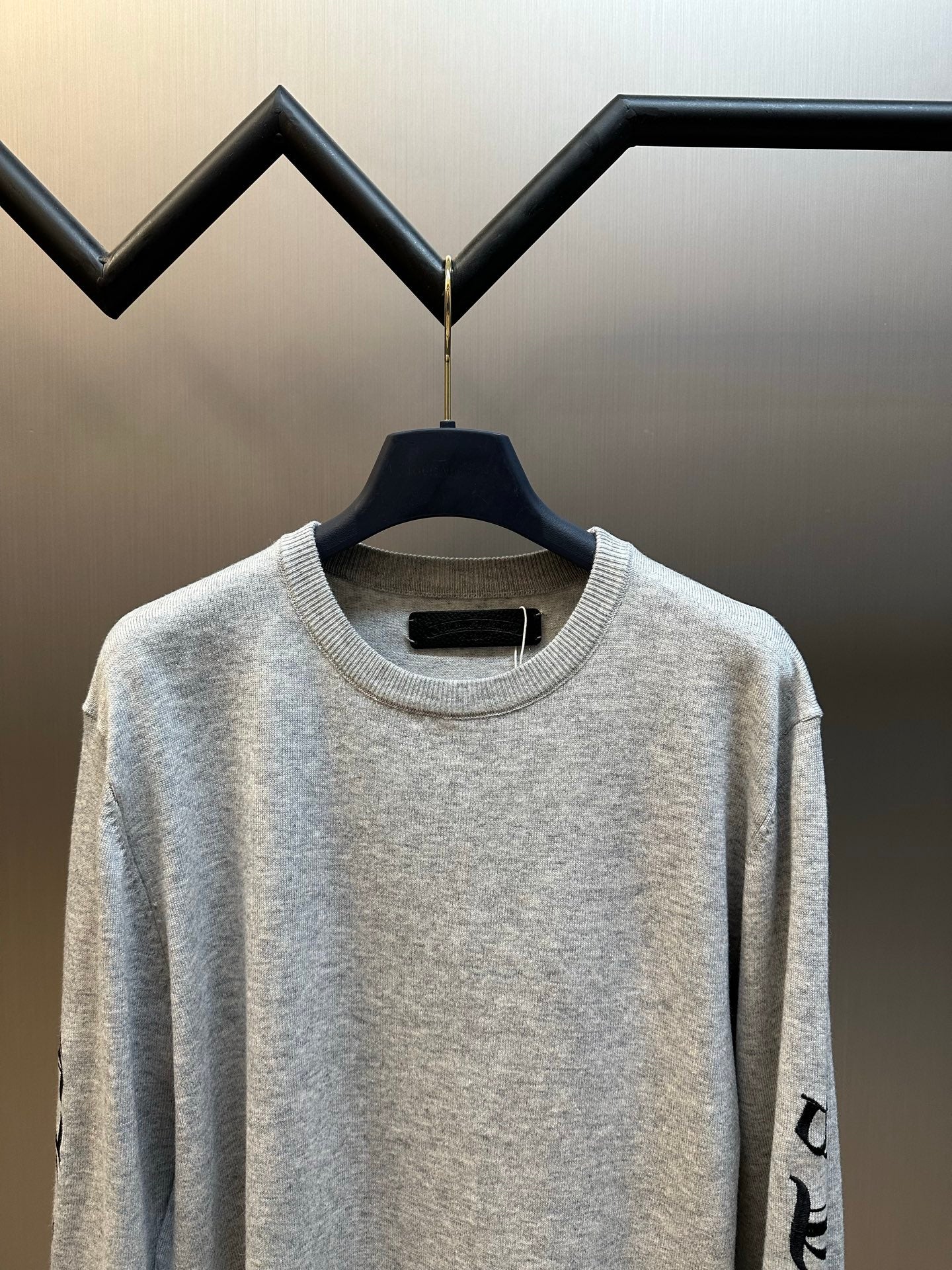 Light gray heather crewneck sweatshirt with ribbed collar and black side sleeve print
