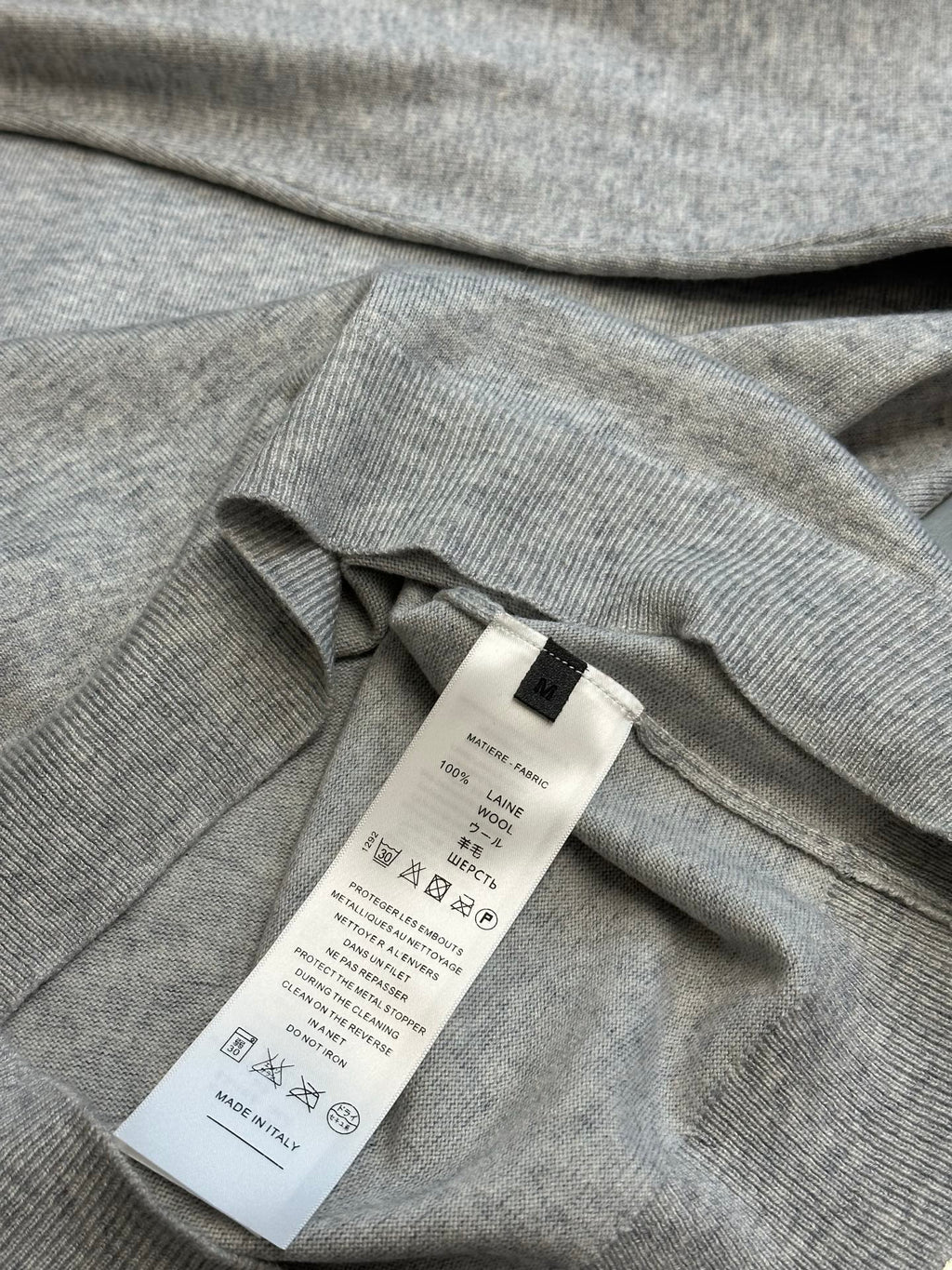 Light gray heather sweatshirt neckline with fabric care and size label