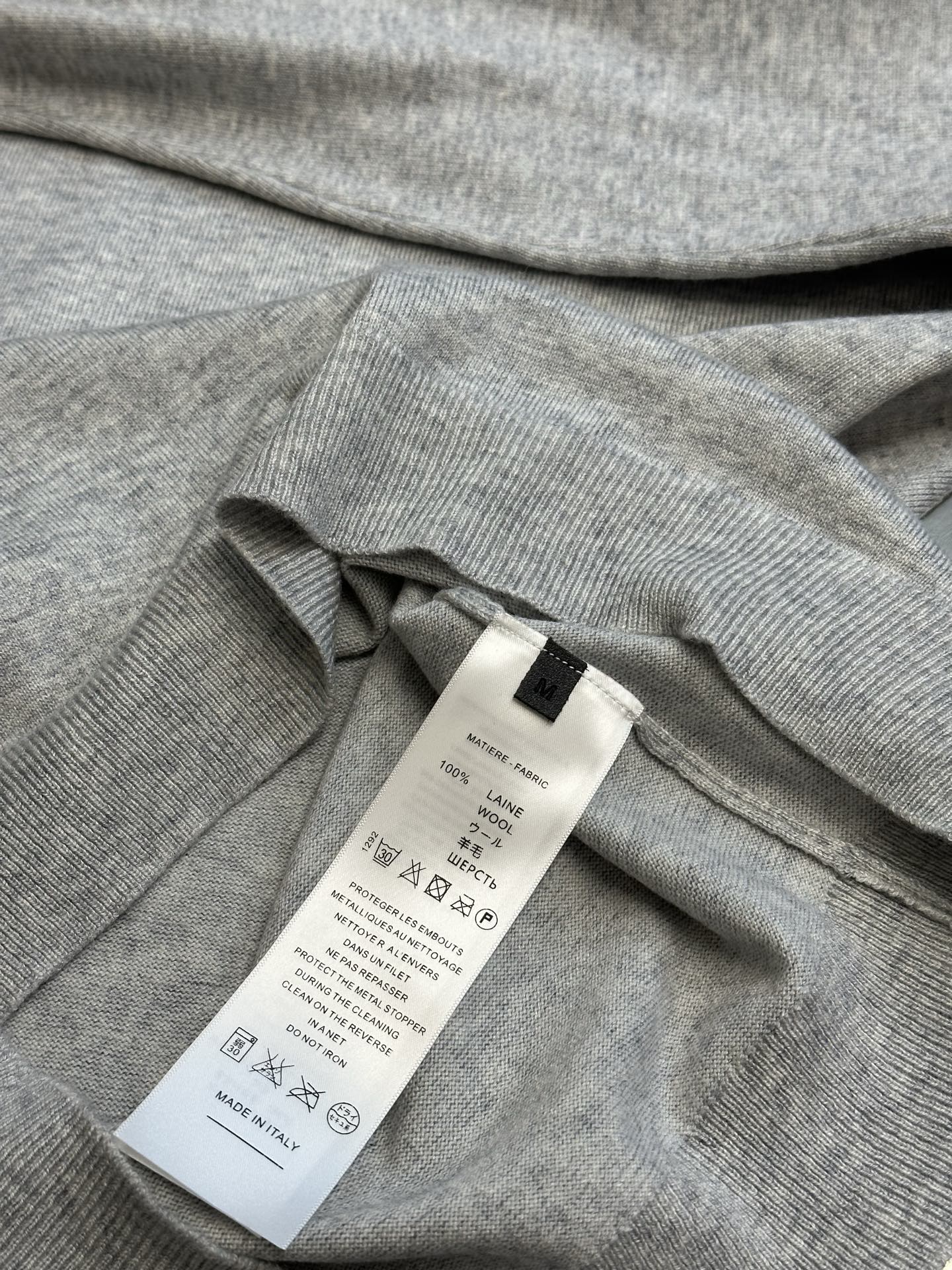 Light gray heather sweatshirt neckline with fabric care and size label