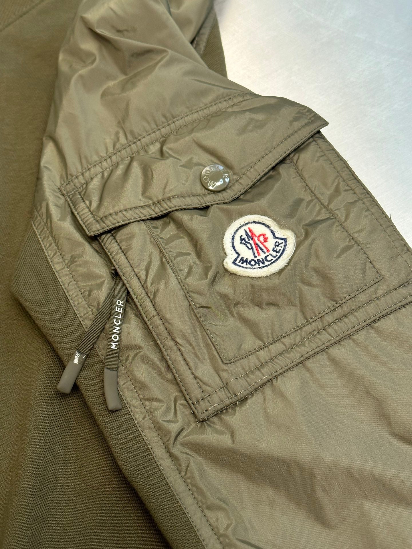 Moncler olive green quilted shoulder patch with round logo emblem