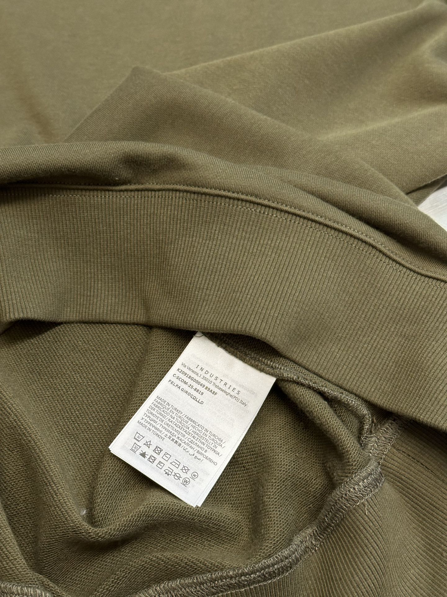Moncler olive green sweatshirt hem with care label sewn near waistband