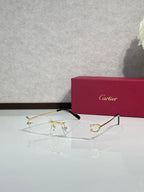 Gold-tone eyeglasses with black temple tips and clear lenses