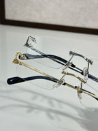 Two eyeglass frames: silver-tone and gold-tone with clear lenses and dark temple tips