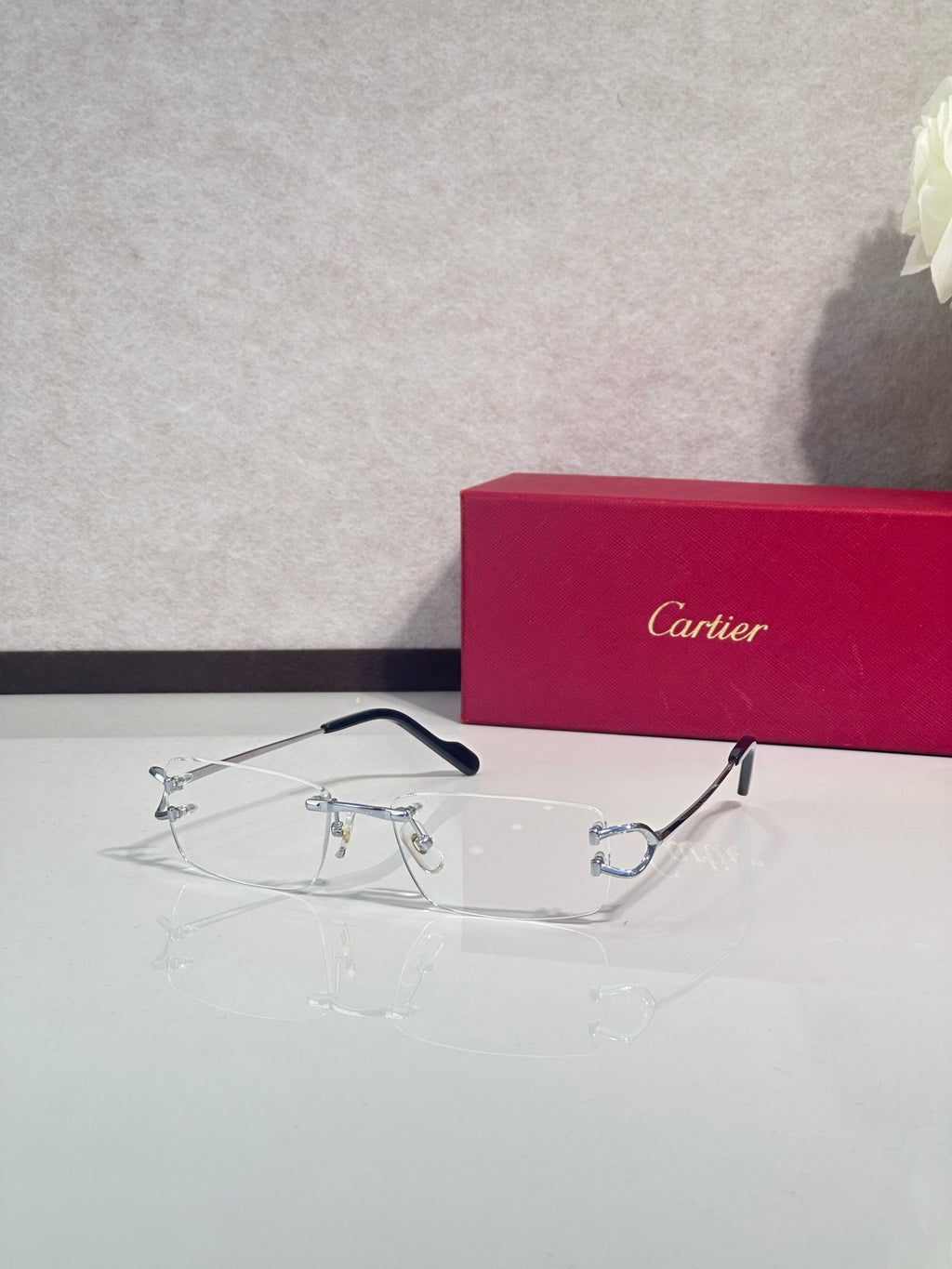 Silver-tone eyeglasses with blue temples and thin metal rims, clear lenses