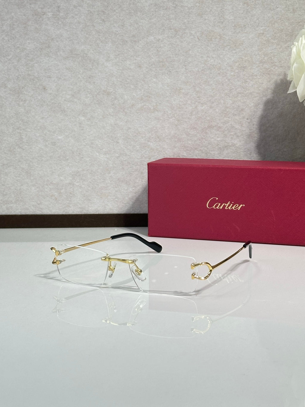 Gold-tone eyeglasses with black temples and clear lenses