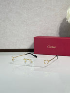 Gold-tone eyeglasses with black temples and clear lenses
