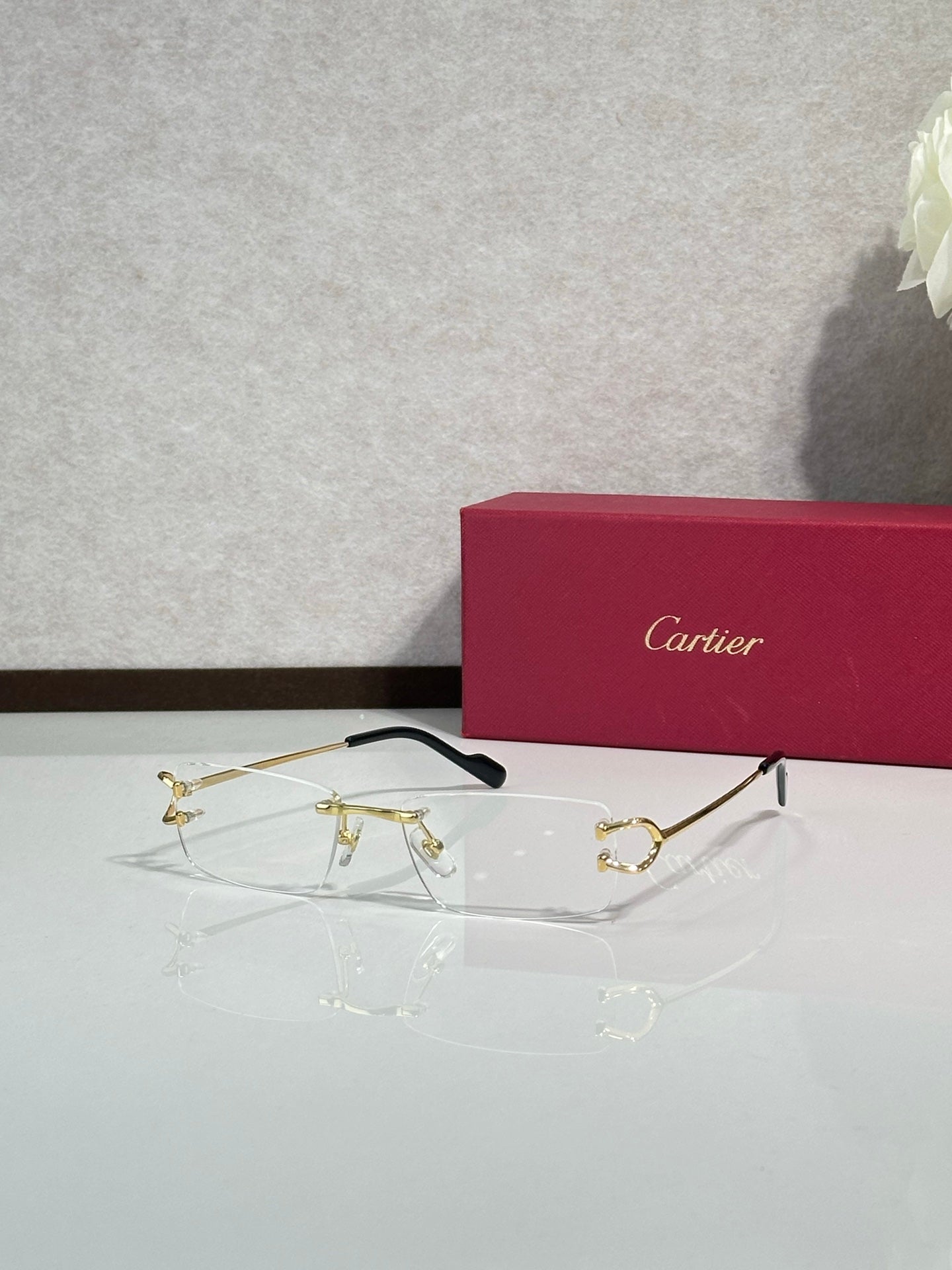 Gold-tone eyeglasses with black temples and clear lenses