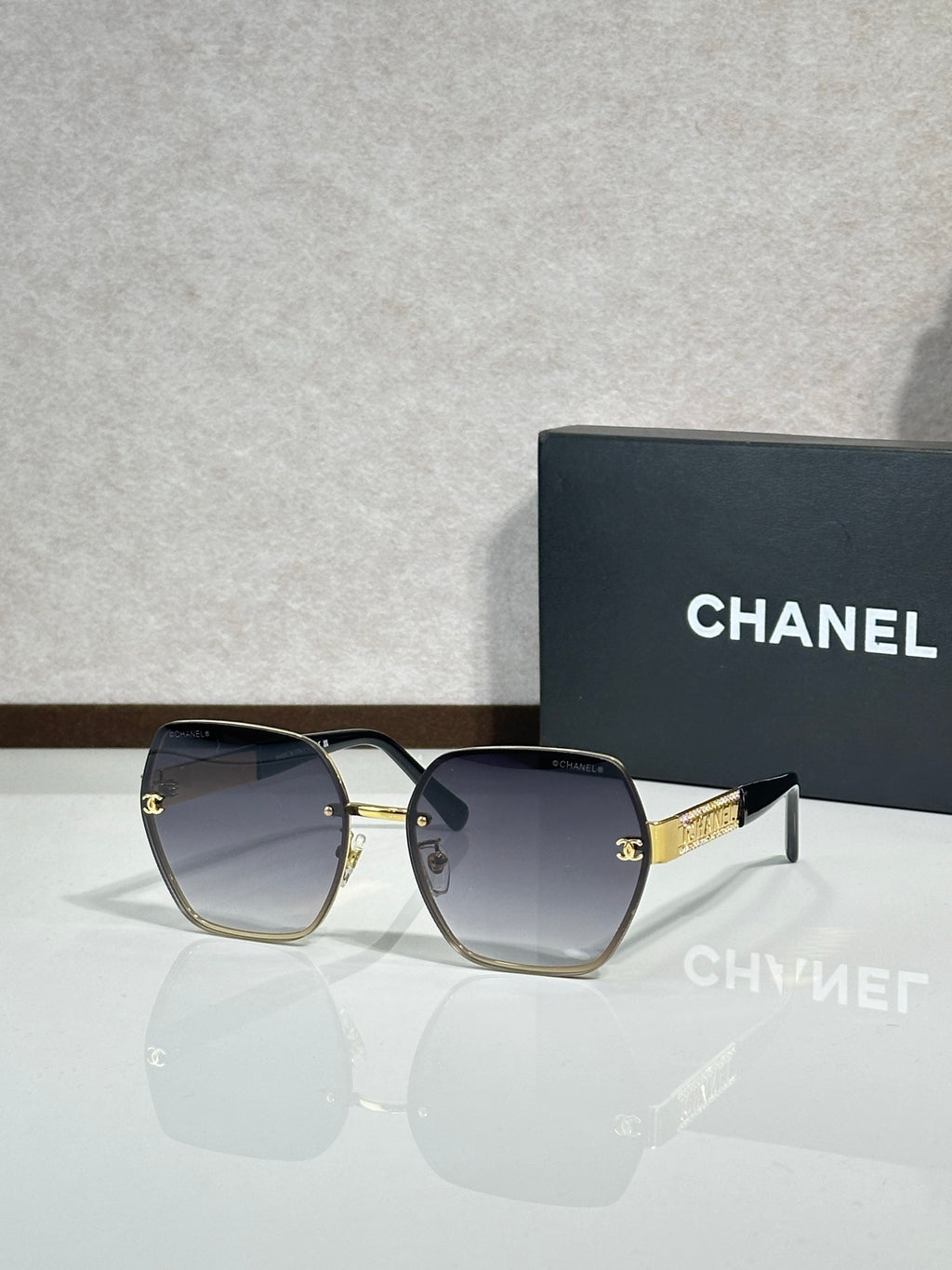 Chanel glasses with dark frames and blue gradient lenses