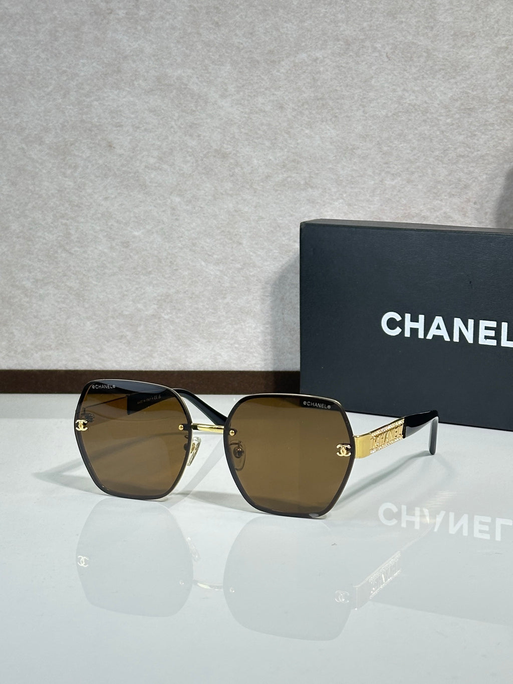 Chanel glasses with black frames and brown-tinted lenses