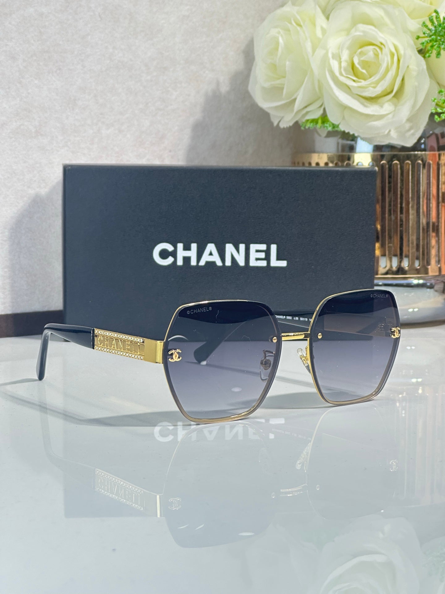 Chanel glasses with navy frames and blue-tinted lenses